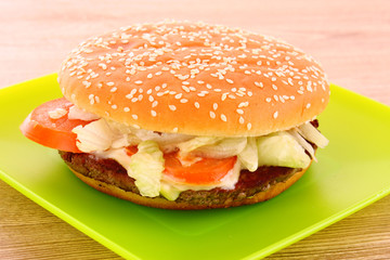 hamburger with vegetables on the table