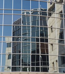 Office building reflection in another building