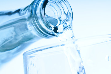 bottle pouring water into  glass