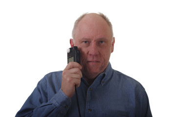 Older Man in Blue Denim Shirt Holding Light Meter to Face