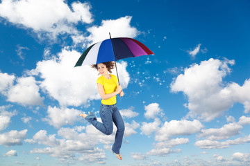flying woman with rainbow umbrella on White clouds, collage