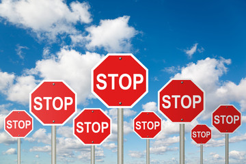 many stop signs on White, fluffy clouds in blue sky collage