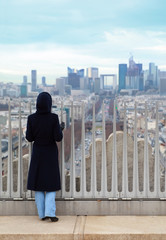Fototapeta na wymiar woman standing on Triumfaly arch and looking at La Defense