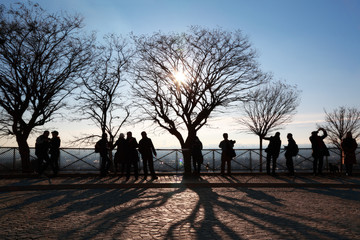 Tourists in Paris on observation platform looking at panorama