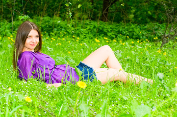 young woman resting on meadow