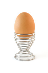 Isolated boiled egg in metal egg cup