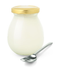 Isolated yogurt. Closed glass jar of fresh natural yogurt and spoon isolated on white background