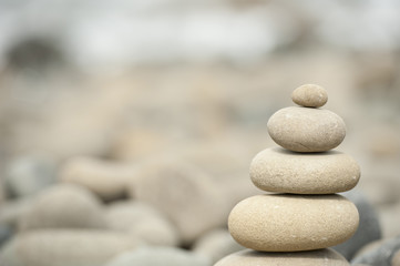 Fototapeta na wymiar stack of balanced rocks on rocky beach