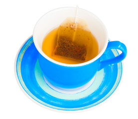 Blue cup with a tea bag isolated on a white background