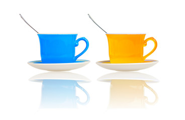 Colorful cups with reflections on a white background