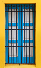 Blue window on a bright yellow wall