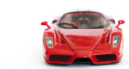 Red sport car miniature on white background