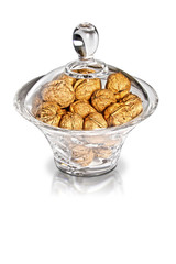 walnuts in a jar against white background