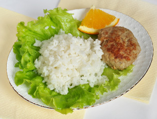 Home cooking, cutlet with rice and vegetables