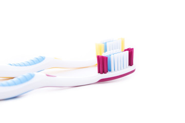 red and yellow toothbrushes