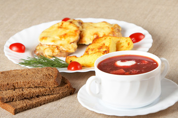 Soup and meat in French with fried potatoes
