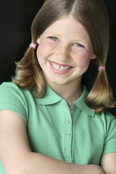 Young Girl With Pigtails In Green Polo Shirt