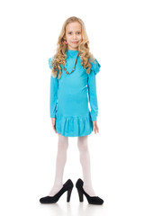 Portrait of a young girl in moms shoes