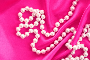 Smooth elegant red silk background with pearls