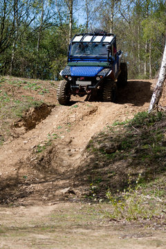 off road vehicle descending a steep hill