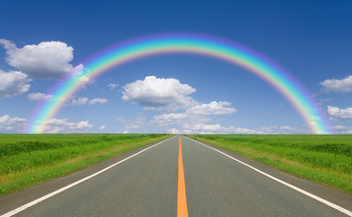 Rainbow over straight road