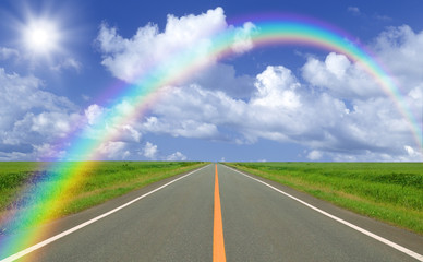 Rainbow over straight road