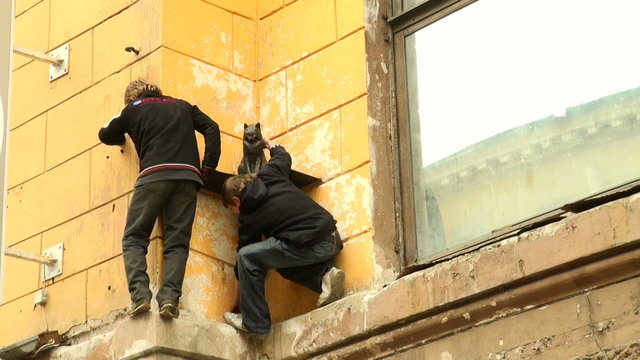 The boys climb on the wall