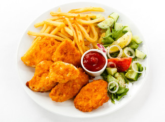 Fried chicken nuggets, French fries and vegetables