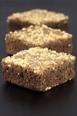 chocolate brownies with cracked peanuts on top