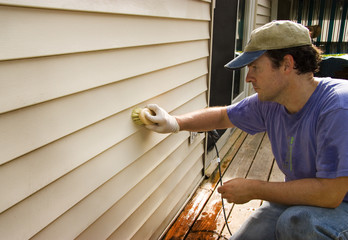 Washing Vinyl Siding of House