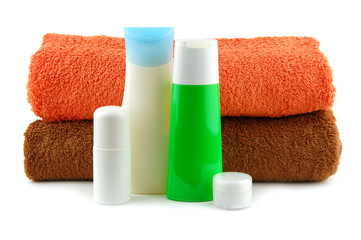 Fototapeta na wymiar Cosmetic bottles with bath towels
