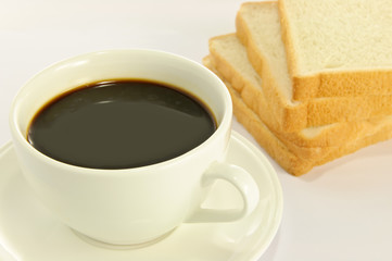 Breakfast with coffee and bread on table