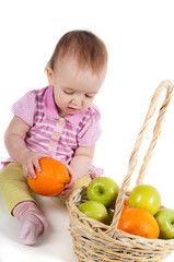 Fototapeta na wymiar Baby girl in pink and fruits