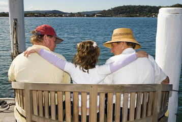 Family sitting on thw water edge