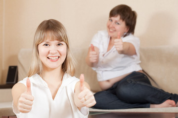 Happy  women showing thumb up sign