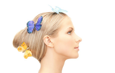 Obraz na płótnie Canvas beautiful woman with butterfly in hair