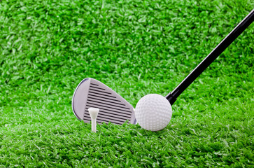 golf ball and tee's on golf course with 7 iron