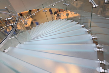 modern glass spiral staircase in shop with motion step