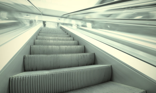 angle view to modern green steps of moving business escalator