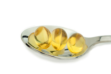red and yellow tablet in spoon
