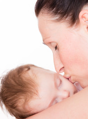 mother kissing sleeping baby