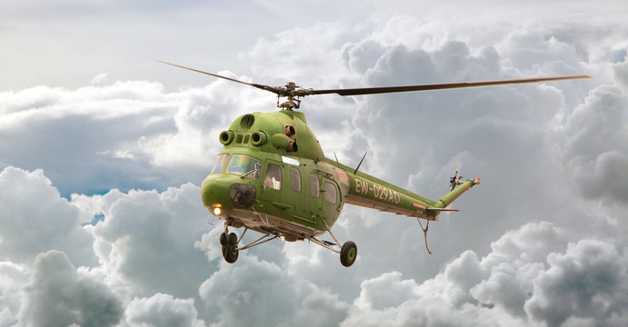 Helicopter MI-2 flight, Russia against clouds