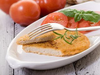 slice vegetarian cutlet with slice tomatoes