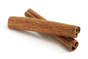 Two cinnamon sticks isolated on white background. Close up.