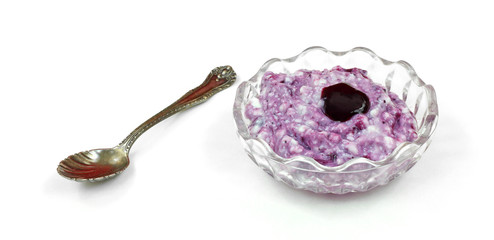 Cottage cheese with blueberry sauce and spoon