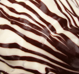 The surface of the cake with white and chocolate icing