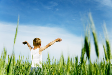 Freedom - Child with her arms spread looks to the sky
