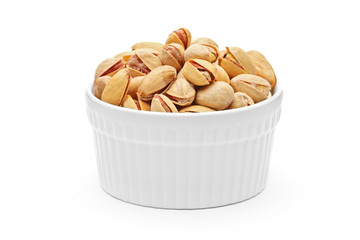 Salted and roasted pistachio nuts in a porcelain bowl