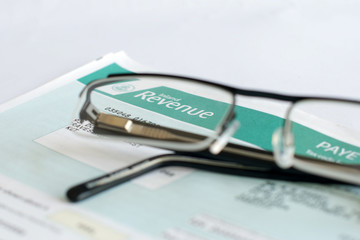 Inland revenue tax form focused through glasses lense