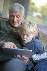 Grandfather and grandson using Tablet PC